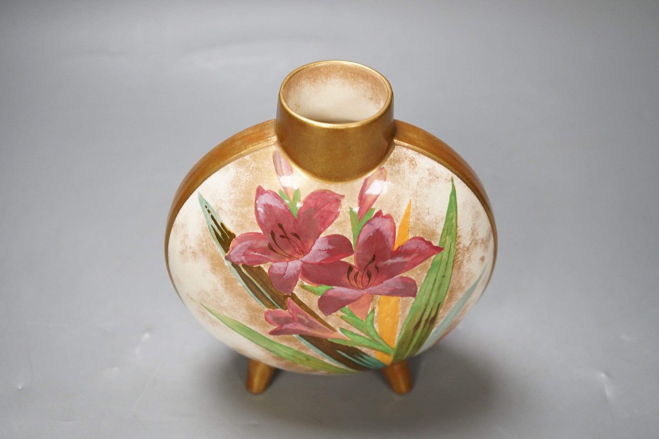 A Doulton style moonflask with painted flower lily decoration. 16cm high